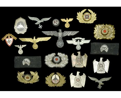 German Second World War Headdress Insignia. Including a Luftwaffe Trophelm eagle with eagle facing left. A highly unusual Fir