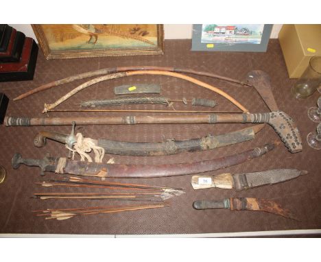 A collection of various weapons including curved dagger with white metal handle; another dagger; swords; arrows; bows etc