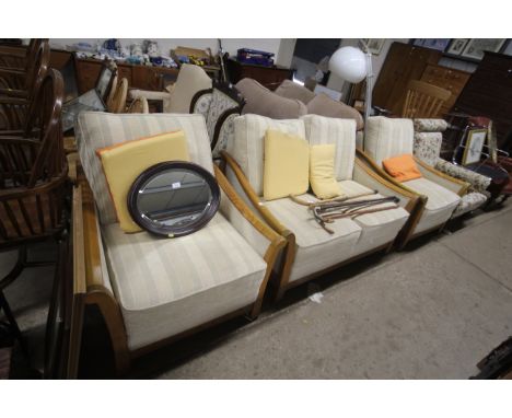 An Ercol style three piece suite comprising of two seater settee and two matching armchairs 