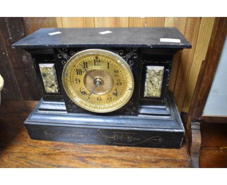 A Victorian black slate and metal mantel clock, having gilt face