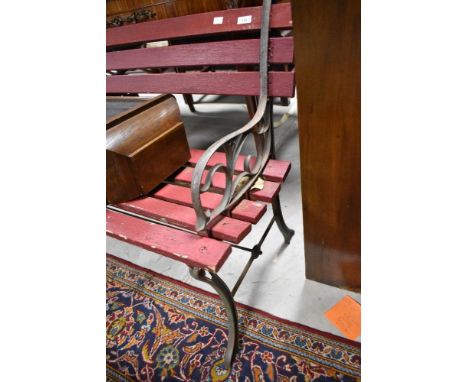 A vintage slatted garden bench having metal supports, width approx. 122cm