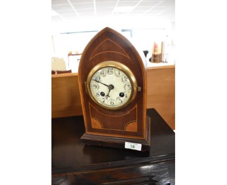 An Edwardian mahogany mantle clock of bishops mitre form, with enamelled face and foilate embellishments