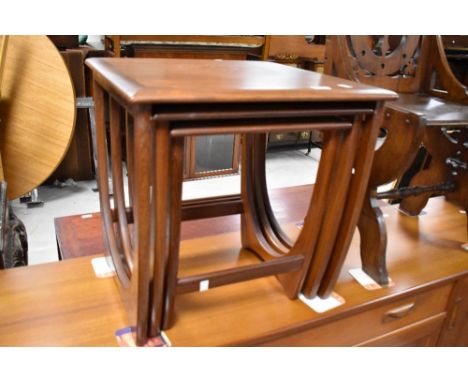 A vintage teak nest of three stylised tables in the G Plan Astro style