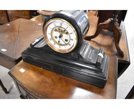 A Victorian black slate mantel clock having visible movement with enamelled roman numeral dial
