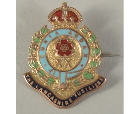 A 9CT GOLD AND ENAMEL LANCASHIRE FUSILIER BROOCH.