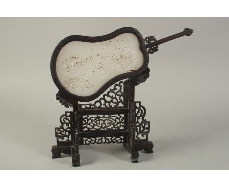 A CHINESE WHITE JADE FAN on a wooden stand. 12ins high.