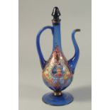 A PERSIAN BLUE GLASS JUG with reverse portraits.