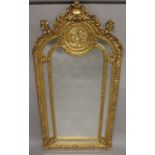 A VERY GOOD LOUIS XVITH DESIGN GILTWOOD MIRROR with cupids, scrolls etc. 7ft high x 2ft 6ins wide.