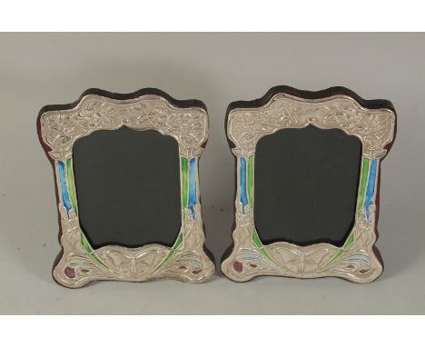 A PAIR OF ART DECO DESIGN SILVER AND BLUE ENAMEL BUTTERFLY PHOTOGRAPH FRAMES. 8 x 6ins.