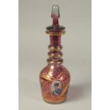 A GOOD RUSSIAN RUBY GLASS DECANTER AND STOPPER with gilt decoration and and oval portrait of a