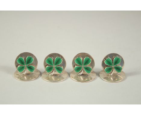 A SET OF FOUR S. MORDAN &amp; Co. SILVER AND GREEN ENAMEL IRISH MENU HOLDERS, decorated with enamel clover leaves, in a fitte