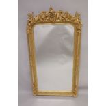 A GOOD GILTWOOD MIRROR with cupids and acanthus. 5ft high x 2ft 7ins wide.