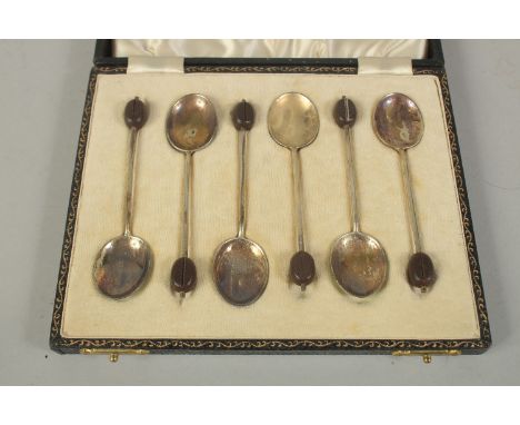 A SET OF SIX BEAN END COFFEE SPOONS with enamel bowls, cased.