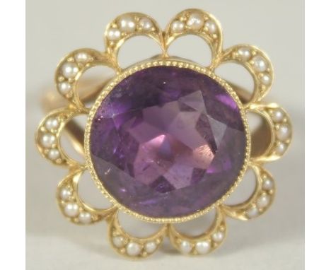 A PURPLE STONE AND SEED PEARL RING. Size M.