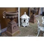 A GOOD LARGE PAIR OF VICTORIAN STYLE CAST IRON TWIN HANDLED PEDESTAL URNS, on tapering square bases