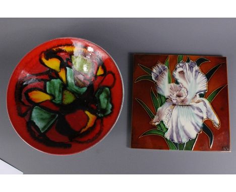 Majolica tube lined tile, marked A.N, approx 30 x 30 cms together with large Poole pottery fruit bowl approx 34 cms d x 16 h 