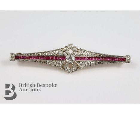 French Art Deco 18ct and platinum diamond and ruby brooch. The brooch set with a central old-cut diamond approx 25 pts and th