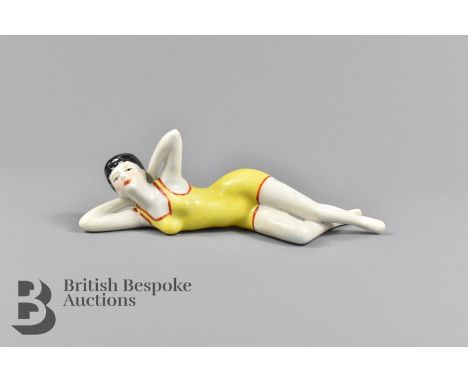 A ceramic Art Deco style figurine, approx 15 cms in length.&nbsp;