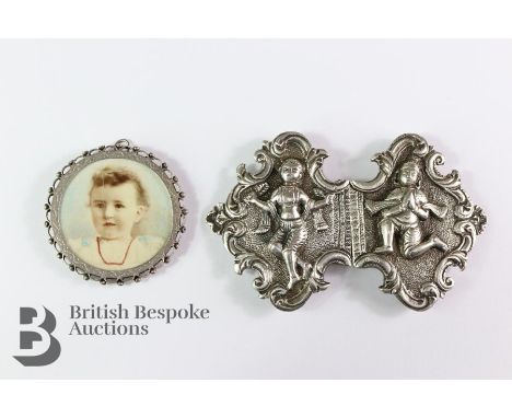 Indian silver buckle, together with a silver portrait pendant depicting a young woman, Birmingham hallmark dated 1893, approx
