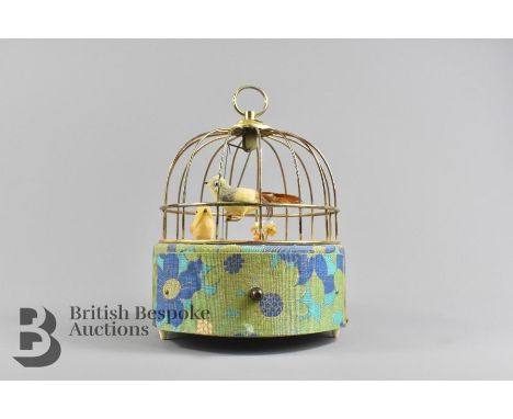 Musical automaton jewellery box, circular in design with a small bird swinging when the mechanism is wound, approx 22 cm h x 