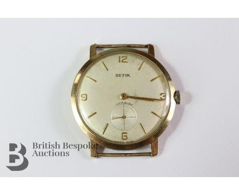 Gentleman's 9ct Hefik gold wrist watch, the watch having a champagne face with baton and numeric dial, weight with movement, 