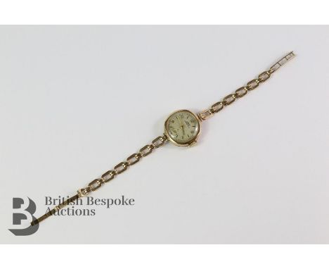 Lady's 9ct yellow gold Juno wrist watch, on a 9ct gold chain. The watch having a champagne face with baton and numeric dial a