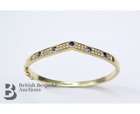 18ct yellow gold sapphire and diamond wishbone bracelet with matching ring. The bracelet set with five 3 x 2mm sapphires and 