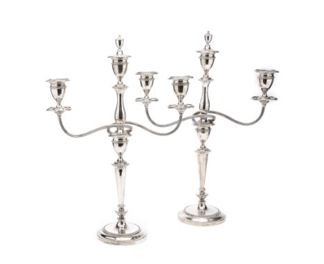 A PAIR OF GEORGE V SILVER CANDELABRA, GEORGE EDWARDS &amp; SONS, SHEFFIELD, 1910 the loaded sticks with circular bases and fl