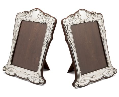 ☐ A PAIR OF EDWARDIAN SILVER-MOUNTED PHOTOGRAPH FRAMES, E. MANDER & SON, BIRMINGHAM, 1902/04 the shaped and relief mounts wit