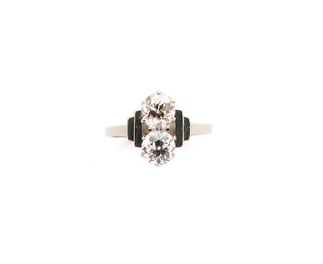 TWO STONE DIAMOND RING, 1930s claw set with two circular-cut diamonds, to geometric shoulders