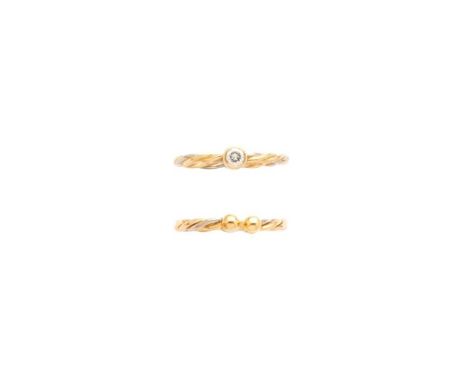CARTIER: A DIAMOND RING AND A TORQUE RING, 1990s the diamond ring collet set with a brilliant-cut diamond to a tri-colour rop