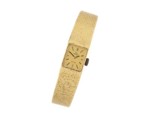 OMEGA, DE VILLE: LADY'S GOLD BRACELET WATCH seventeen jewel manual wind movement, rectangular matte gilt dial with black bato