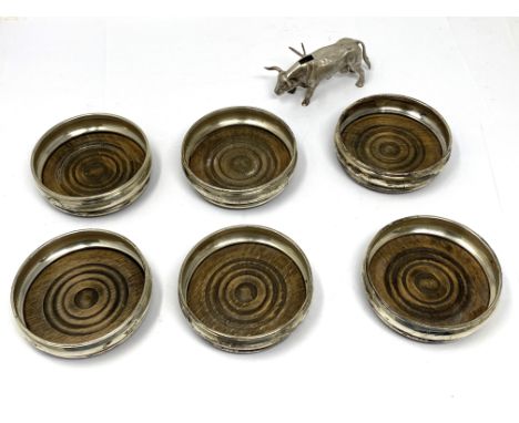 A SET OF SIX SILVER COASTERS, A. CHICK &amp; SONS LTD., LONDON, 1969 with bulging silver sides and turned wood bases, 8cm dia