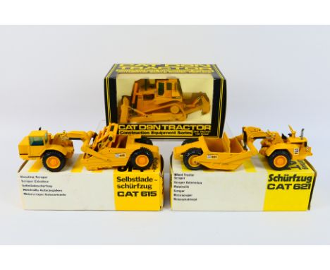 NZG - 3 x boxed Caterpillar construction vehicles, a CAT 621 tractor scraper # 122, a CAT 615 tractor scraper # 260 and a CAT