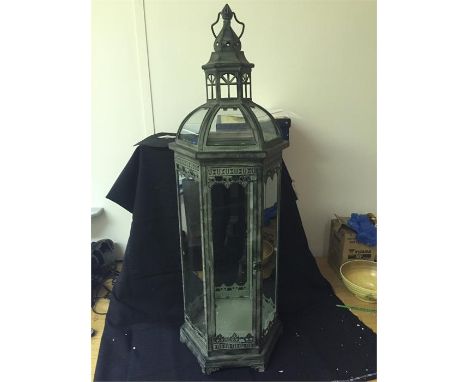 Large lantern approximately four foot tall.  One broken pane of glass.