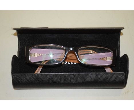 A pair of glasses stamped Prada