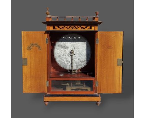 The Britannia Polyphon with 44cm discs, the walnut case with pierced gallery above two doors raised upon low turned feet, com