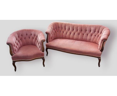 A Victorian mahogany sofa, the buttoned upholstered back with scroll arms raised upon cabriole legs together with a matching 