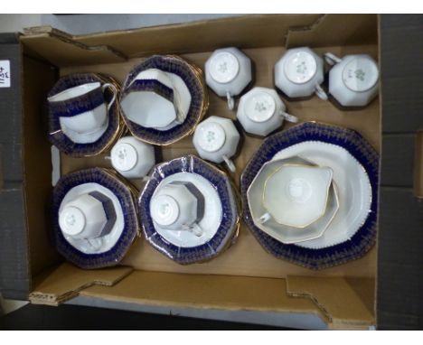 Delphine China tea ware, cobalt blue and gilt on white, in octaganol form: 2 cake plates, 11 side plates, 12 saucers, 10 tea 