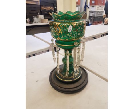 Late 19th/Early 20th century green glass table lustre, decorated with gilt and enamel floral sprays, raised on a circular woo