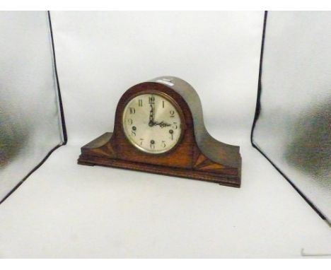 Oak cased Art Deco mantle clock, key and pendulum present.