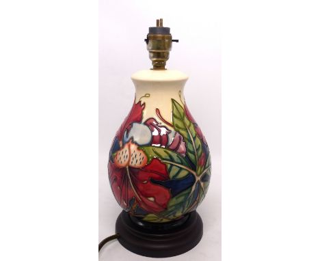 Moorcroft table lamp decorated in the Simeon pattern by Philip Gibson, of baluster form on turned wooden base, 27.7cm high (i