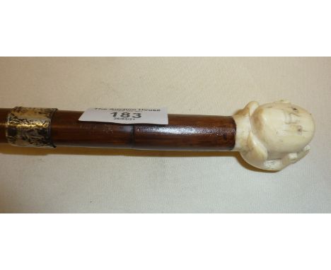 Edwardian walking cane with silver collar and carved bone head in hand finial. Collar hallmarked for London 1919, J. Howell &