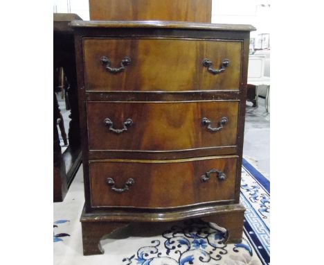 Mahogany serpentine front small chest of three long drawers, raised on bracket feet, width 50cm 