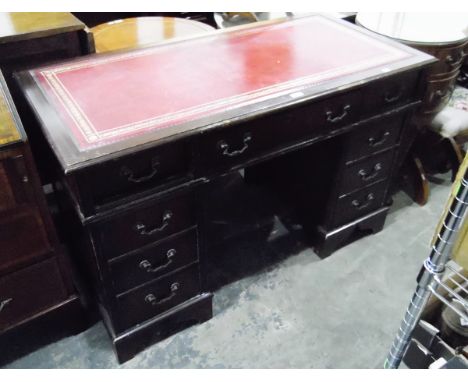 Mahogany pedestal desk with inset writing surface, with three frieze drawers flanked by three short drawers to either side, r