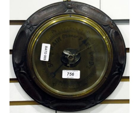 20th century circular aneroid barometer, in carved oak frame, 24cm diameter 