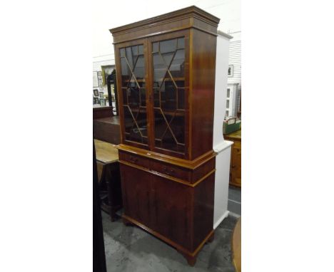 Modern Georgian-style yew wood veneer glazed bookcase, the pair of astragal-glazed doors enclosing adjustable shelves, with t
