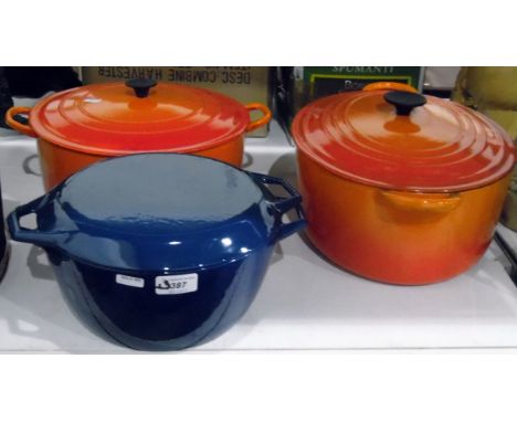 Two large orange Le Creuset casserole dishes and a blue enamel casserole dish marked 'Denmark' 