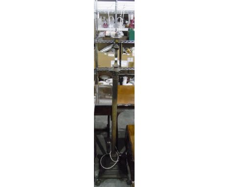 Brass standard lamp with reeded column, on square stepped base and splayed paw feet 