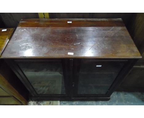 Old mahogany glazed bookcase, the pair of panelled doors enclosing shelf, raised on a plinth, width 92cm 